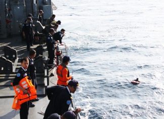 Thai Navy crewmen aboard the HTMS Similan pluck from the sea survivors of the Sirichai Nava 11 that had been sunk after Somali pirates hijacked it in the Gulf of Eden.